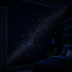 Op de afbeelding: Een donkere slaapkamer met een sterrennachtthema. De muren en het plafond zijn donkerblauw geschilderd, met talrijke kleine, gloeiende witte en blauwe lichten die zijn gerangschikt om op een melkweg te lijken. Een bed met blauw beddengoed en een nachtkastje met een lamp en een teddybeer zijn zichtbaar.