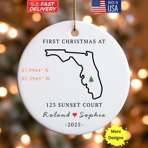 May include: White ceramic Christmas ornament with a black outline of Florida and a green Christmas tree. Text includes "FIRST CHRISTMAS AT", coordinates, address, names "Roland & Sophia", and the year "-2025-".