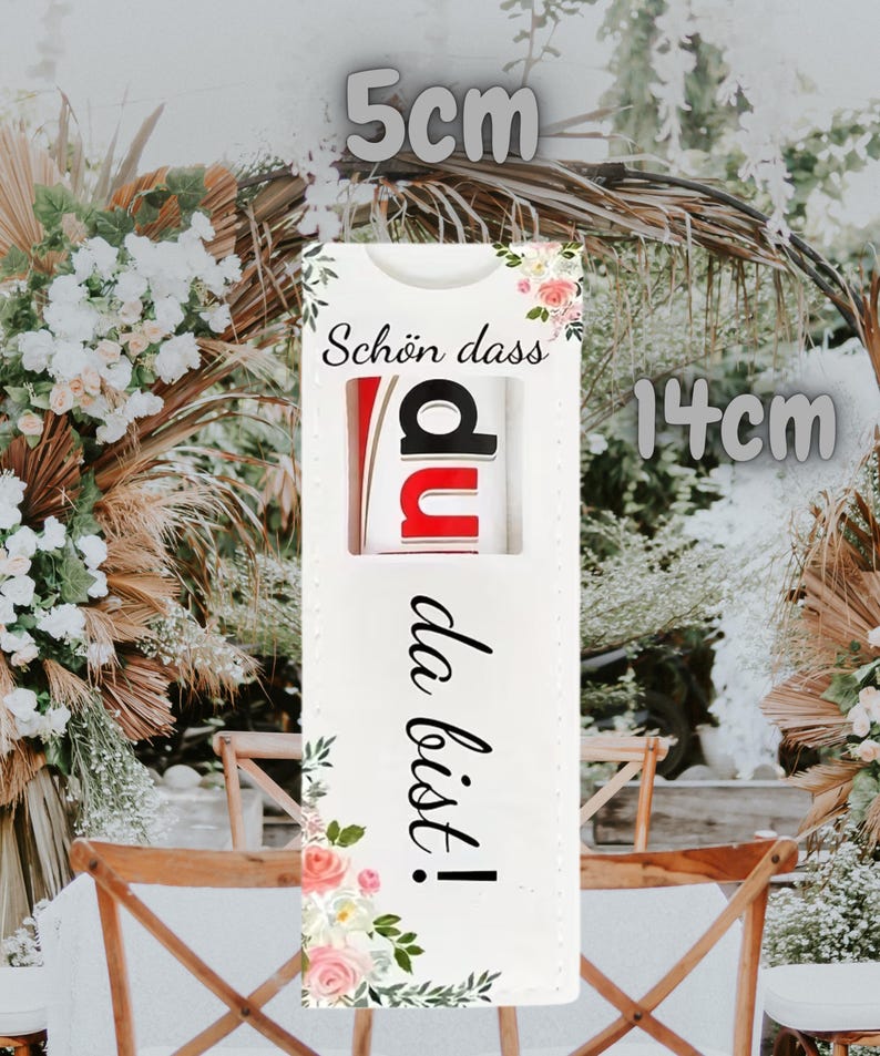May include: A white rectangular gift tag, 5.5 inches long and 2 inches wide, with the German text "Sch&ouml;n dass du da bist!" and floral accents. The tag features a cutout revealing the letters "du" in red and black.
