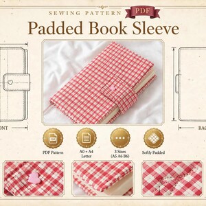 May include: A sewing pattern for a padded book sleeve featuring a red and white gingham fabric cover with a small pink heart detail on the closure tab. The document includes front and back technical line drawings, three size options, and detailed close-up views of the fabric texture and stitching.
