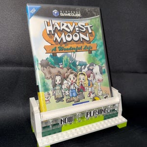 UNIVERSAL Currently Playing Video Game/DVD Stand