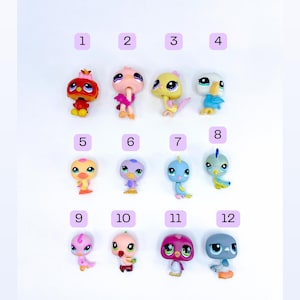 May include: A collection of twelve small plastic animal figurines arranged in three rows of four, each labeled with a number from 1 to 12. The figures include various colorful birds and creatures with large eyes, featuring shades of red, pink, yellow, blue, purple, and grey.