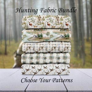 May include: A stack of fabric bundles with hunting-themed patterns. The top bundle features deer and a hunter, followed by a landscape scene, deer antlers, plaid, and flying ducks. Text reads "Hunting Fabric Bundle" and "Choose Your Patterns."