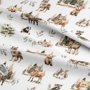 May include: White fabric with a repeating watercolor pattern of woodland animals, including foxes, wolves, deer, raccoons, and bears. The design also features trees and branches with berries, creating a nature-themed print.