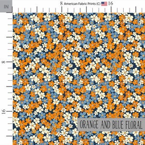 May include: A fabric print featuring a dense pattern of small five-petaled flowers in shades of bright orange, light blue, and cream against a dark navy blue background. A ruler border indicates a scale of 16 inches by 16 inches.