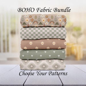 May include: A stack of five rolled fabric bundles with various patterns. The top bundle has a floral and rainbow design. Other patterns include checkered, daisy, heart, and geometric prints. The text "BOHO Fabric Bundle" and "Choose Your Patterns" are displayed.