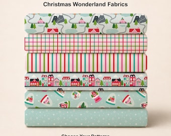 May include: A stack of six folded fabric bolts featuring Christmas Wonderland Fabrics. Patterns include a road with cars and mountains, a red and green plaid, vertical stripes, a row of houses, snow globes, and a light blue fabric with white stars.