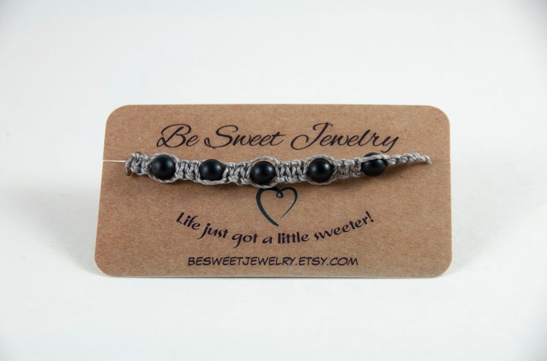 Gray macrame bracelet with black beads and wax cord