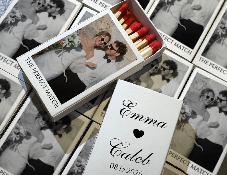 May include: White matchboxes with a black and white photo of a couple wearing sunglasses. The text "THE PERFECT MATCH" is printed on the box. The open box reveals red-tipped matches. A separate box has the names "Emma" and "Caleb" with a heart and the date "08.15.2026".