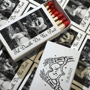 May include: White matchboxes with a black and white photo of a couple, and the text "Til Death Do Us Part." The matchbox contains red-tipped matches. Another box features skeleton hands forming a heart with the initials "S+K" and the date "11.18.2025."