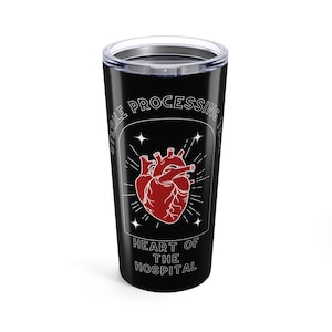 May include: Black 20 oz tumbler with a red anatomical heart design. The text reads "STERILE PROCESSING" and "HEART OF THE HOSPITAL" in white. The design includes star and ray accents.
