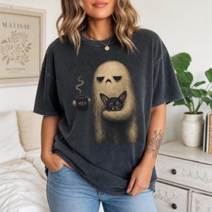 A grumpy ghost embraces a chihuahua while holding a "MEH" coffee mug.