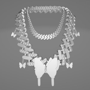 May include: A silver-colored necklace with a layered design. The necklace features a series of interconnected geometric shapes and small butterfly charms. The focal point is a large butterfly pendant. The necklace is displayed against a gray background.