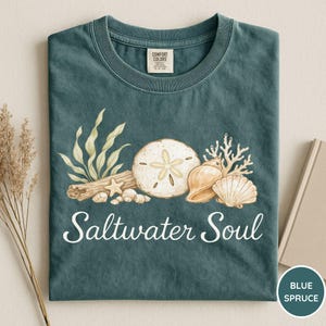 May include: A white ceramic mug with a black handle and the text "But First, Coffee" in a black, handwritten-style font. The mug is likely 11-15 ounces in size, perfect for a morning beverage.