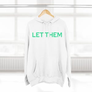 May include: White hooded sweatshirt with a green text print that says "LET THEM" on the front.