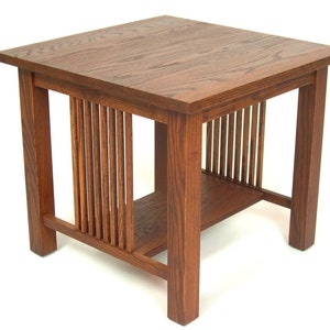 May include: A square, wooden side table with a dark brown finish. The table features a slatted design on the sides and a lower shelf. The table is approximately 24 inches tall and 24 inches wide.