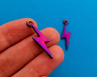 May include: Two iridescent purple lightning bolt charms with a hole at the top for attaching to jewelry or other crafts.