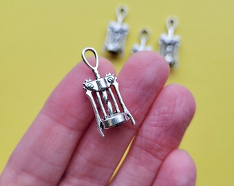 May include: Silver corkscrew charm pendant. The charm is in the shape of a traditional corkscrew with a handle and a spiral.