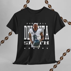 デボンタ・スミス イーグルス ユニセックス Tシャツ NFL グッズ フットボールファンシャツ 試合日用アパレル スポーツウェア ギフト ヴィンテージ風 美的服