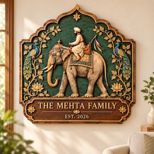 May include: A decorative wall plaque featuring a relief carving of a person riding an elephant, flanked by two peacocks and lotus flowers on a dark green background. Below, a wooden panel displays the text THE MEHTA FAMILY and EST. 2026.