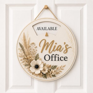 May include: A round, cream-colored hanging door sign featuring the text "AVAILABLE" at the top and "Mia's Office" in the center. The sign is decorated with a cluster of dried-style flowers, leaves, and grasses in shades of beige, white, and sage.