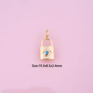May include: Gold padlock charm with a blue evil eye design. Size: 19.3x8.5x2.4mm
