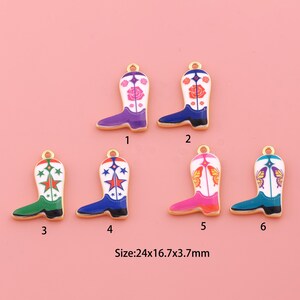 May include: Six metal cowboy boot charms with gold-tone edges and enamel details. Each charm measures 24x16.7x3.7mm. Designs include floral, star, and butterfly motifs in purple, blue, green, pink, and teal colors with white accents.
