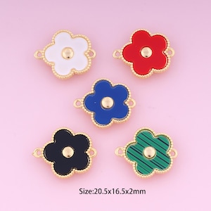 May include: Five gold-colored flower-shaped charms with different colored enamel centers. The charms are 20.5 mm x 16.5 mm x 2 mm in size. The colors are white, red, blue, black, and green.