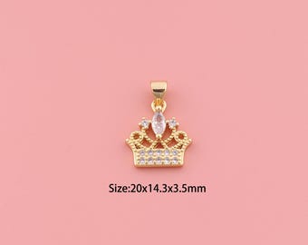 May include: Gold-colored crown pendant with clear crystals and a large central stone. The pendant measures 20mm x 14.3mm x 3.5mm. The crown design features a loop for attaching to a chain or bracelet. The background is a solid pink color.