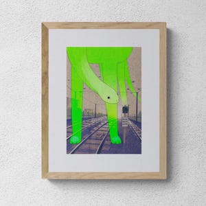 May include: A framed art print featuring a giant, translucent neon green creature with a long neck standing over dark blue railroad tracks. A small sign near the tracks reads "RADIO DEPOT ENTRY" beneath a green signal light against a muted sky.