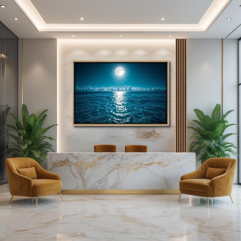 May include: An interior shot of a modern reception area. A large framed artwork depicts a moonlit ocean scene. The space features a marble reception desk, two mustard-colored armchairs, and potted plants. The floor is marble tile.