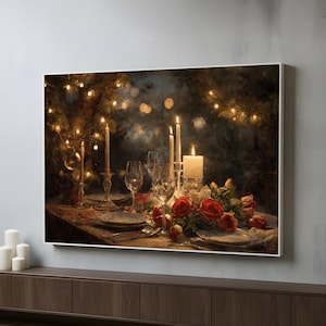 May include: A framed print of a romantic dinner setting. The table is set with plates, silverware, wine glasses, and lit candles. A floral arrangement of red roses and white flowers adorns the table, creating a warm and inviting atmosphere.