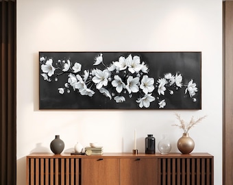 May include: A black and white canvas print featuring a close-up of a white cherry blossom branch with delicate petals against a dark background.