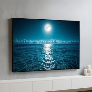 Moonlit ocean canvas wall art featuring a glowing full moon reflecting across calm sea waves, tranquil coastal nightscape framed and ready to hang