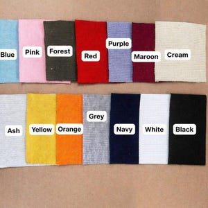 May include: A collection of fabric swatches in various colors, including blue, pink, forest green, red, purple, maroon, cream, ash, yellow, orange, grey, navy, white, and black. Each swatch has a label with its color name.