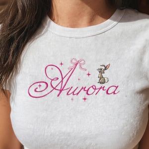 Aurora Embroidered Baby Tee, Sleeping Beauty Inspired, Pink Script Font with Bunny Design, Cute Disney Aesthetic Minimal Top