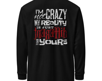 May include: Black long-sleeve shirt with white and red text that reads "I'M not CRAZY MY REALITY IS JUST DIFFERENT THAN YOURS". The text has a distressed, vintage look. The shirt has a crew neck and long sleeves.