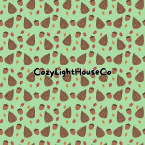 May include: A seamless pattern featuring brown pine cones, acorns, and orange and red leaves on a light green background. The text "CozyLightHouseCo" is centered on the pattern.