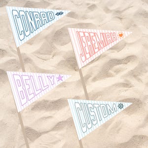 May include: Four triangular pennant flags with names and designs on a sandy background. The flags read "Conrad", "Jeremiah", "Belly", and "Custom". Each flag has a different color scheme and design, including stripes, a star, a sun, a ship's wheel, and a nautical knot.