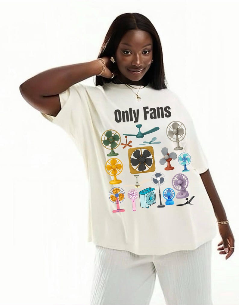 May include: Cream-colored t-shirt with the text "Only Fans" and various fan illustrations in different colors and styles. The shirt is a relaxed fit.