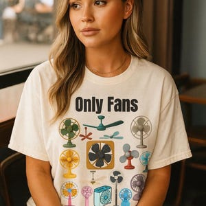 May include: Cream-colored t-shirt with the text "Only Fans" in black block letters. The shirt features a colorful graphic of various fans, including ceiling fans, oscillating fans, and box fans.