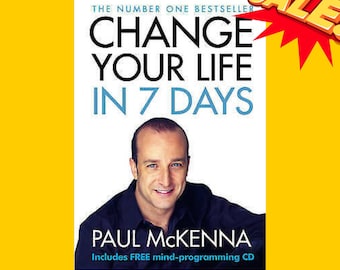 May include: A book cover with a white background and blue text that reads "Change Your Life in 7 Days". The author's name, "Paul McKenna", is printed in black below the title. The cover features a photo of a man with short brown hair and a light blue shirt. The text "The Number One Bestseller" is printed in black at the top of the cover. The text "Includes FREE mind-programming CD" is printed in black at the bottom of the cover.