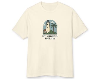 May include: A cream-colored t-shirt with a graphic of a lighthouse and palm tree with the text "St. Marks Florida".