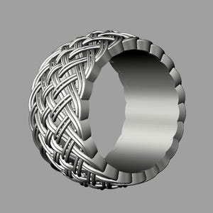 May include: A silver ring with a woven design. The ring is thick and has a rounded shape.