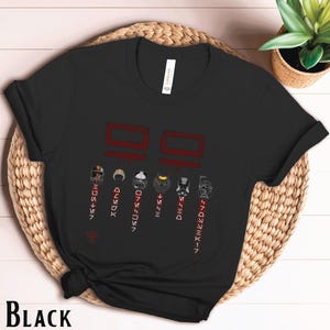 May include: Black t-shirt with a graphic of the Star Wars clone troopers from the Bad Batch. The graphic includes the clone troopers' names and numbers. The text "Bad Batch" is written in red.