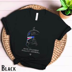 May include: Black t-shirt with a white outline of a helmet and the text "Good soldiers follow orders..."
