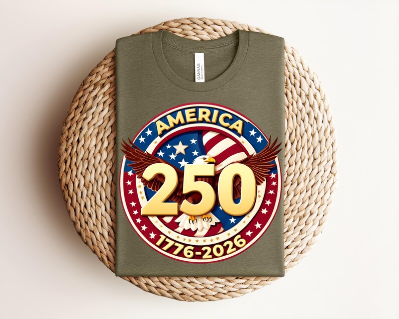 May include: An olive green t-shirt with a circular graphic featuring an eagle, the word "AMERICA", the number "250", and the years "1776-2026". The graphic is in red, white, blue, and gold.