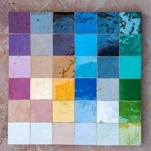 May include: A square arrangement of 30 colorful square tiles. The tiles display a variety of colors, including shades of blue, green, yellow, purple, and brown. The tiles are arranged in a grid pattern, creating a visually appealing display of color variations.