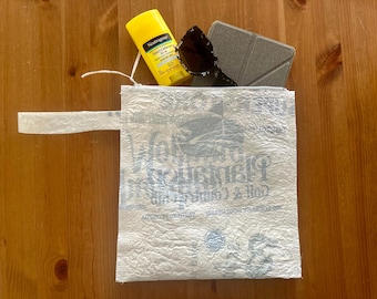 Blue and White text Upcycled water resistant zipper pouch