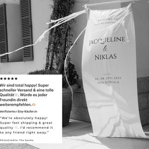 May include: A white wedding banner with the text "WELCOME TO THE WEDDING" and the names "JACOJELINE & NIKLAS". The banner also includes the date "06.-08. JUNI 2025" and location "SON BUMOLA".